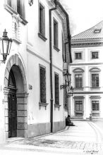 Prague street with a male sitting on the ground