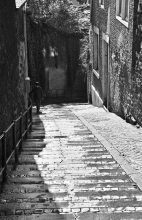 Boy walking down paved stairs in Liége