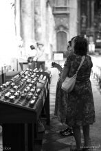 Women burning candles for Our Lady in Lisbon