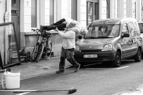 Two male Workers having fun during a job in a street in Antwerp