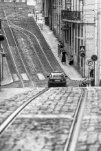 Family on street with tram tracks, Lisbon