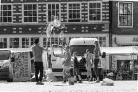 Soap Bubbles artist with children playing on a square in Amsterdam