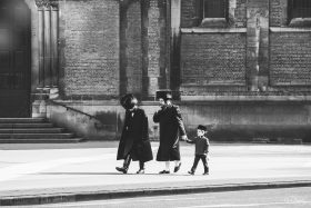 Chareidim Jews en route in front of the Russian Orthodox church