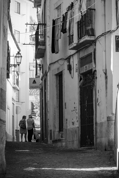 Tourist couple in small street in Lisbon
