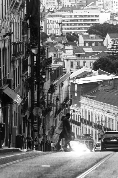 Couple crossing steep streets in Lisbon